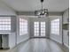 Bright dining area with modern lighting fixture and French doors leading outside at 5151 Tennis Ct, Las Vegas, NV 89120