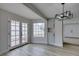 Bright dining room features double doors, large window, wood-look tile flooring, and a modern light fixture at 5151 Tennis Ct, Las Vegas, NV 89120