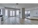 Bright dining area with modern lighting fixture and French doors leading outside at 5151 Tennis Ct, Las Vegas, NV 89120