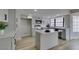 Bright kitchen features gray cabinets, stainless steel appliances, quartz countertops, and a functional island at 5151 Tennis Ct, Las Vegas, NV 89120
