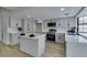 Well lit kitchen featuring stainless steel appliances, a kitchen island, and new cabinets at 5151 Tennis Ct, Las Vegas, NV 89120