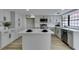 Spacious kitchen featuring a central island, stainless steel appliances and shaker cabinets at 5151 Tennis Ct, Las Vegas, NV 89120