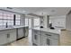 Open kitchen overlooking the dining area boasts a center island, stainless steel appliances, and quartz countertops at 5151 Tennis Ct, Las Vegas, NV 89120