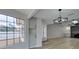 Open living room boasts wood-look tile flooring, a modern light fixture, and a cozy fireplace at 5151 Tennis Ct, Las Vegas, NV 89120