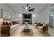 Beautifully staged living room with plush seating, stylish decor, fireplace, and ample natural light at 5151 Tennis Ct, Las Vegas, NV 89120