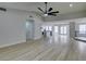 Open concept living room with wood floors that leads to the kitchen and dining room at 5151 Tennis Ct, Las Vegas, NV 89120