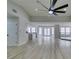 Spacious living room featuring wood floors with an open layout to the modern kitchen and dining area at 5151 Tennis Ct, Las Vegas, NV 89120