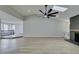 Bright living room features a fireplace, skylight, wood floors, and a modern ceiling fan at 5151 Tennis Ct, Las Vegas, NV 89120