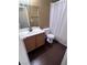 Bathroom featuring a wood vanity, toilet, and shower with a white shower curtain at 5217 Yellow Dawn Ct, Las Vegas, NV 89130