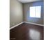 Bright bedroom with dark wood flooring and a large window for natural light at 5217 Yellow Dawn Ct, Las Vegas, NV 89130
