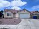 Charming single story home featuring a two car garage and low maintenance desert landscaping at 5217 Yellow Dawn Ct, Las Vegas, NV 89130