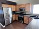 Efficient kitchen with stainless steel appliances, functional layout, and light wood cabinets at 5217 Yellow Dawn Ct, Las Vegas, NV 89130