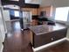 Kitchen with stainless steel appliances, breakfast bar, light wood cabinets, and dark flooring at 5217 Yellow Dawn Ct, Las Vegas, NV 89130