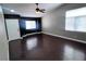 Spacious living room with high ceilings, dark accent wall, wood flooring, and abundant natural light at 5217 Yellow Dawn Ct, Las Vegas, NV 89130