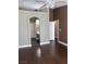 This main bedroom includes dark wood flooring and an arched entrance to an ensuite bathroom at 5217 Yellow Dawn Ct, Las Vegas, NV 89130