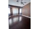 Spacious main bedroom featuring dark wood floors, neutral walls, and a ceiling fan with lighting at 5217 Yellow Dawn Ct, Las Vegas, NV 89130