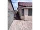 Side yard shows a walkway between a stucco home and a concrete block fence at 5217 Yellow Dawn Ct, Las Vegas, NV 89130