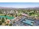 Beautiful aerial view capturing the golf course, lake, clubhouse, tennis courts, and residential homes within the community at 5401 Indian Hills Ave, Las Vegas, NV 89130