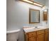 This bathroom features a single sink vanity, framed mirror, and standard toilet at 5401 Indian Hills Ave, Las Vegas, NV 89130