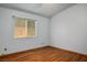 This bedroom features wood laminate flooring and a large window with natural light at 5401 Indian Hills Ave, Las Vegas, NV 89130
