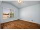 This bedroom includes wood laminate flooring and a large window with mountain views at 5401 Indian Hills Ave, Las Vegas, NV 89130