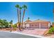 Charming single story home boasting a three-car garage, beautiful landscaping, and mature palm trees at 5401 Indian Hills Ave, Las Vegas, NV 89130