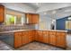 Kitchen features oak cabinets, tile countertops and backsplash, and view into the Gathering room at 5401 Indian Hills Ave, Las Vegas, NV 89130