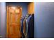 This laundry room features new front load machines, wooden door and upper cabinets at 5401 Indian Hills Ave, Las Vegas, NV 89130