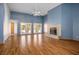 Spacious living room features a fireplace, high ceiling, wood floor, and three French doors at 5401 Indian Hills Ave, Las Vegas, NV 89130
