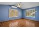 A living room with wood floors, a ceiling fan and views out onto the pool at 5401 Indian Hills Ave, Las Vegas, NV 89130