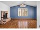 Spacious living room featuring a brick fireplace, wood floors, and a vaulted ceiling at 5401 Indian Hills Ave, Las Vegas, NV 89130