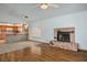 Open concept living room featuring wood floors and view into the kitchen and fireplace at 5401 Indian Hills Ave, Las Vegas, NV 89130