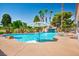 A beautiful swimming pool features a waterfall and multiple palm trees at 5401 Indian Hills Ave, Las Vegas, NV 89130