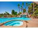 A stunning swimming pool features a spa, waterfall, and mature palm trees at 5401 Indian Hills Ave, Las Vegas, NV 89130