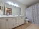 Bathroom with double sinks, spacious countertops, and a shower with a patterned curtain at 5710 E Tropicana Ave # 1018, Las Vegas, NV 89122