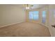 Spacious bedroom with a ceiling fan, outdoor access, and carpet flooring at 5710 E Tropicana Ave # 1018, Las Vegas, NV 89122