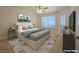 Comfortable bedroom with a ceiling fan and carpet flooring, filled with natural light at 5710 E Tropicana Ave # 1018, Las Vegas, NV 89122