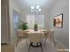Cozy dining area featuring a modern chandelier, round table, and natural light at 5710 E Tropicana Ave # 1018, Las Vegas, NV 89122