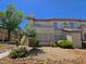 Exterior of a two-story condo with well-maintained landscaping and clearly marked building number at 5710 E Tropicana Ave # 1018, Las Vegas, NV 89122