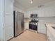 Bright kitchen features stainless steel appliances, white cabinets, and marble countertops at 5710 E Tropicana Ave # 1018, Las Vegas, NV 89122