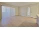 Spacious living room with light wood floors and ample natural light from large sliding doors at 5710 E Tropicana Ave # 1018, Las Vegas, NV 89122