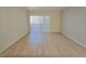 Bright living room with wood floors and sliding doors to balcony at 5710 E Tropicana Ave # 1018, Las Vegas, NV 89122