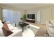 Modern living room with a comfortable white couch, marble coffee table, and bright natural light at 5710 E Tropicana Ave # 1018, Las Vegas, NV 89122