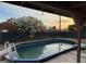 Backyard pool view with flowering tree and sunset, perfect for relaxation at 5920 Glen Eagles Ln, Las Vegas, NV 89108