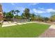 Expansive backyard featuring a pool, artificial turf, and a decorative fire pit at 6013 Jubilee Gardens Ave, Las Vegas, NV 89131