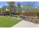 Landscaped backyard featuring a pergola, artificial turf, and mature trees at 6013 Jubilee Gardens Ave, Las Vegas, NV 89131
