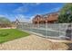 Backyard featuring a swimming pool enclosed by a safety fence, artificial turf, and a two-story home at 6013 Jubilee Gardens Ave, Las Vegas, NV 89131