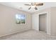 Comfortable bedroom featuring soft carpet, closet, ceiling fan, and a picturesque window view at 6013 Jubilee Gardens Ave, Las Vegas, NV 89131