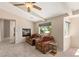 Cozy bedroom nook with a fireplace, two plush armchairs, a side table, and a view of the outdoors at 6013 Jubilee Gardens Ave, Las Vegas, NV 89131