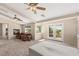 Spacious bedroom with a fireplace, ceiling fans, and access to a private balcony through glass doors at 6013 Jubilee Gardens Ave, Las Vegas, NV 89131